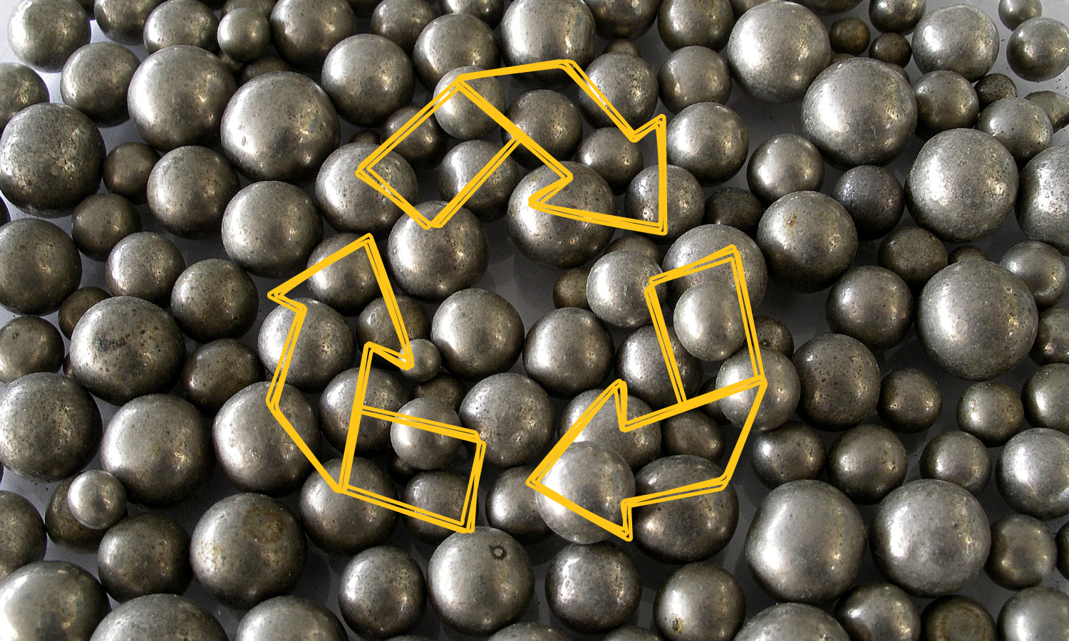 circular nickel pellets with a gold recycle symbol overlaid atop 