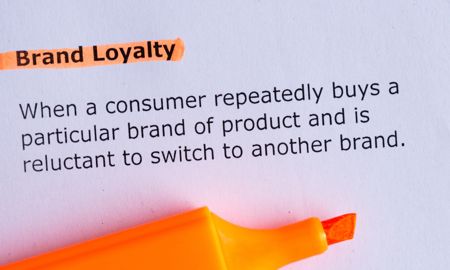a dictionary excerpt showing Brand Loyalty definition highlighted with an orange highlighter